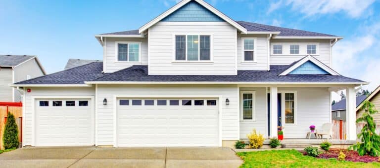 Modern two-story house with white siding and three-car garage