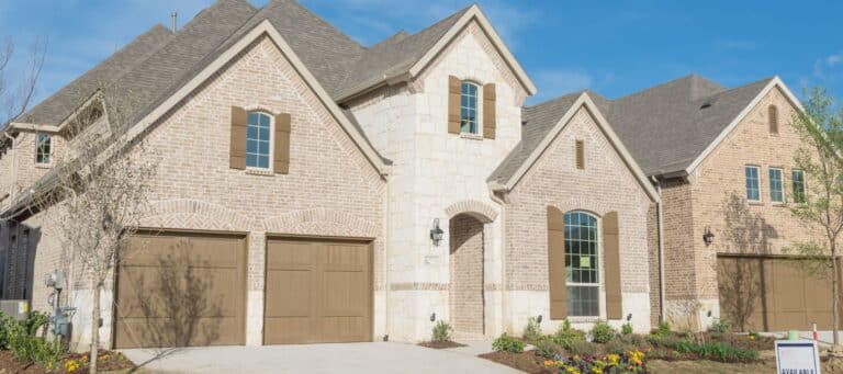 Modern brick house with stone accents and dark wood garage doors