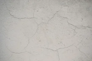 Hairline foundation cracks in a Dallas TX home showing early signs of concrete surface damage from soil movement