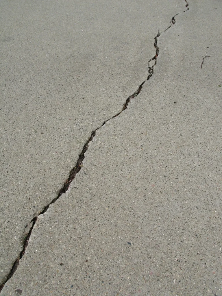 Long diagonal crack in concrete slab caused by foundation settlement in Pflugerville, TX