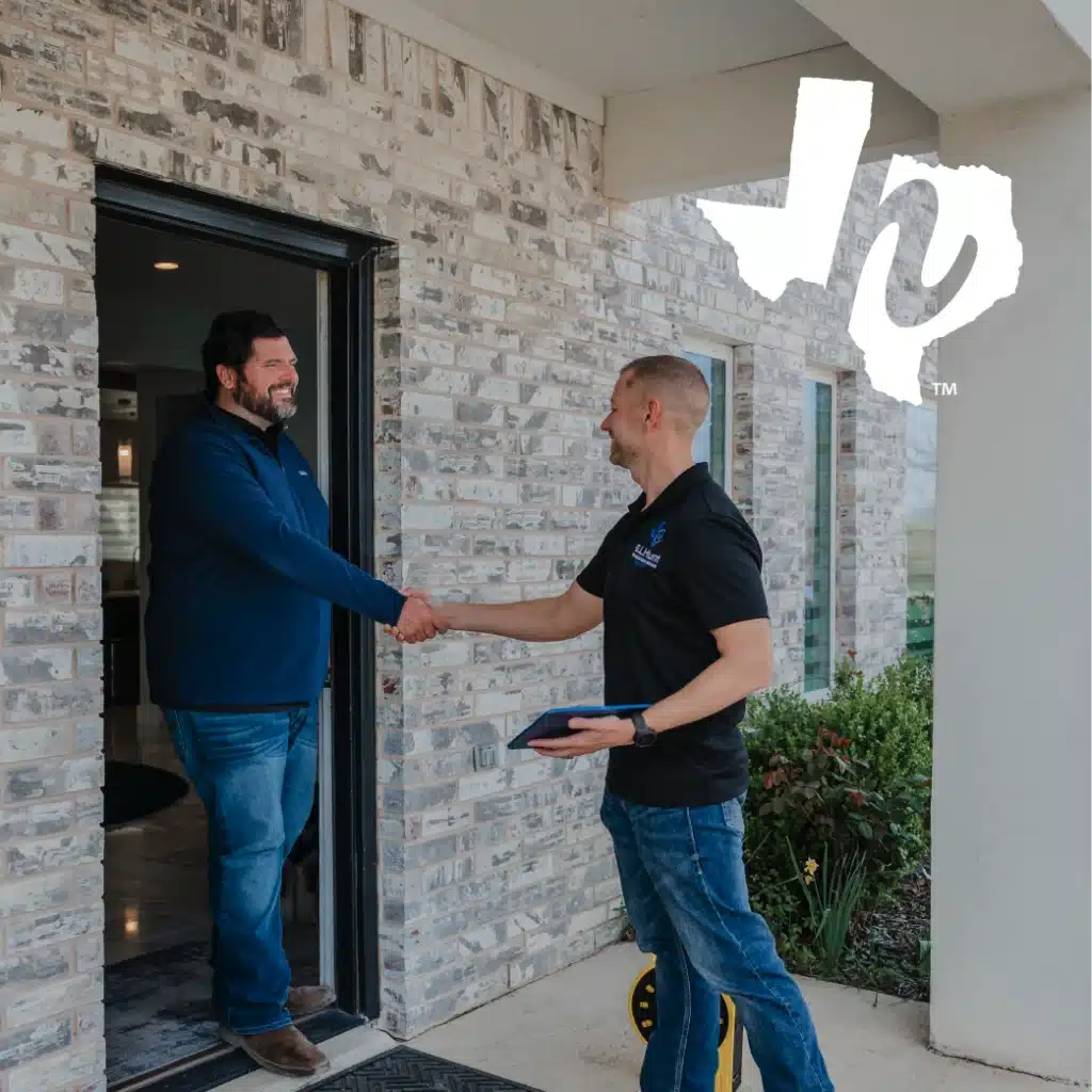 Service technician shaking hands with a homeowner at the front door