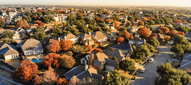 Autumn aerial view of a residential neighborhood with vibrant fall foliage