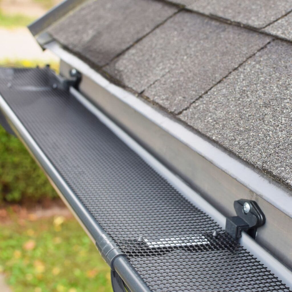 Close-up of a metal gutter guard installed on a roof edge to prevent debris buildup