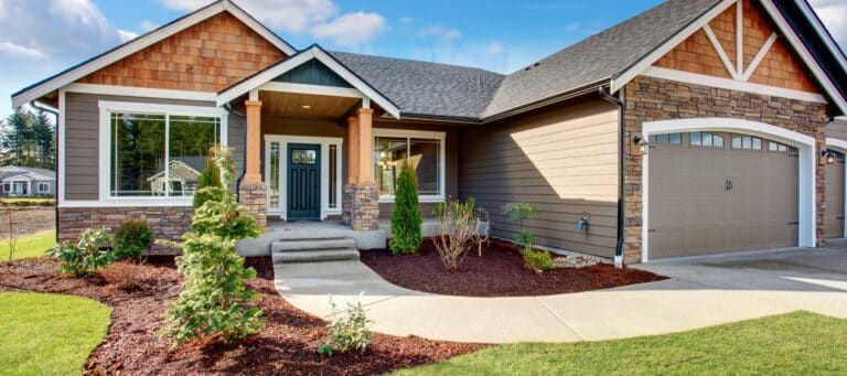 Charming single-story home with a stone façade and neatly landscaped front lawn