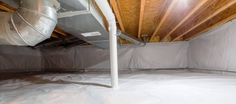Encapsulated crawl space with white vapor barrier and ductwork overhead