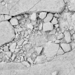 Close-up of cracked and broken concrete surface