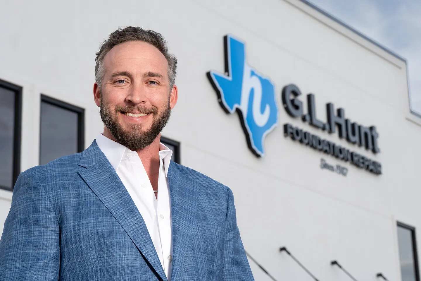 Hayden Slack, Owner and CEO, in front of the G.L. Hunt Foundation Repair headquarters in Fort Worth